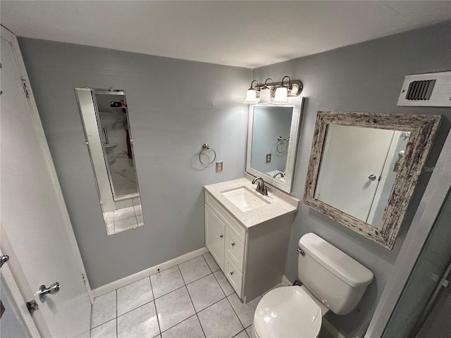 bathroom featuring toilet, vanity, and tile patterned floors