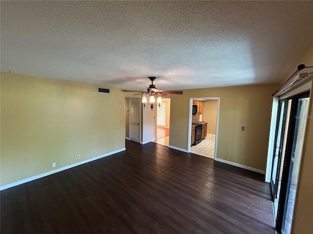 spare room featuring a textured ceiling, ceiling fan, and light hardwood / wood-style floors