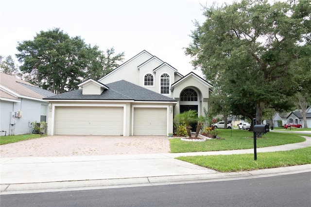 view of front facade featuring a front yard and a garage