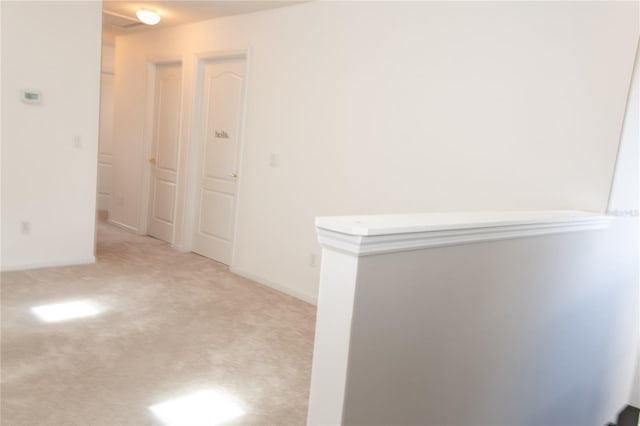 hallway with light colored carpet