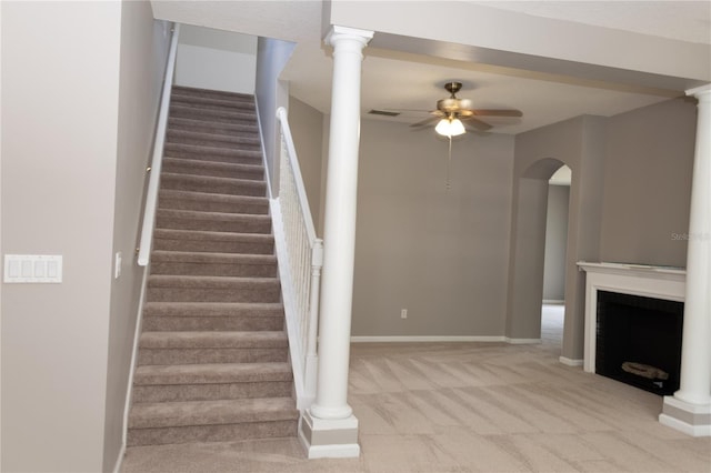 staircase with carpet flooring and ceiling fan