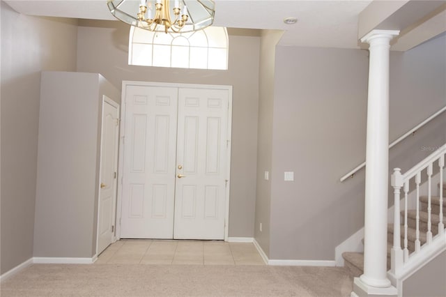 carpeted entryway with a notable chandelier and a towering ceiling