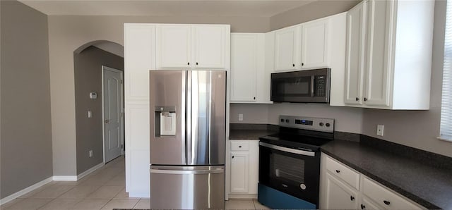 kitchen featuring light tile patterned flooring, white cabinetry, and appliances with stainless steel finishes