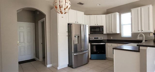 kitchen featuring sink, white cabinets, stainless steel appliances, and light tile patterned floors