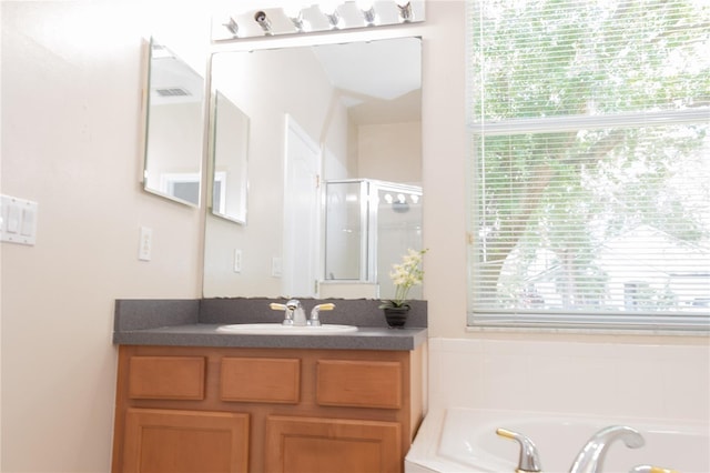 bathroom featuring vanity and shower with separate bathtub