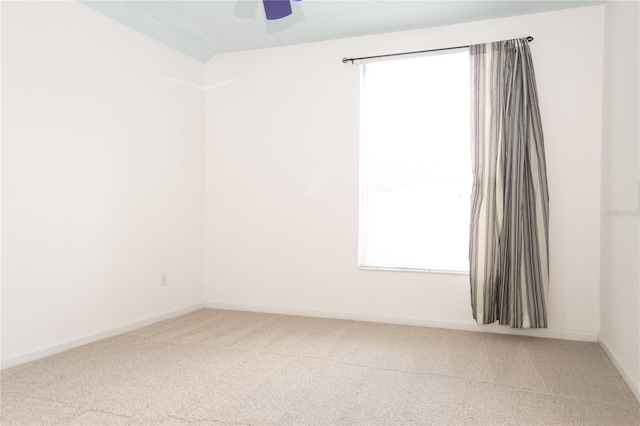 spare room with carpet flooring, ceiling fan, and vaulted ceiling