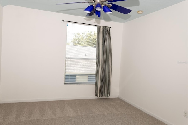 spare room with carpet and ceiling fan