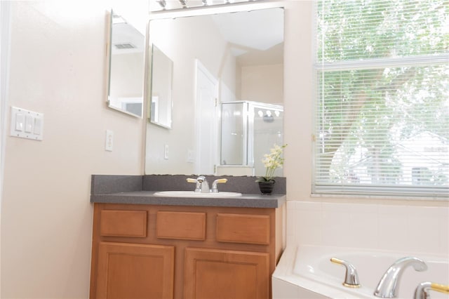 bathroom with shower with separate bathtub and vanity