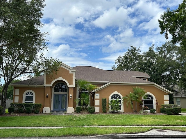 ranch-style house featuring a front yard