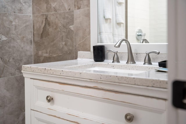 bathroom with tile walls and vanity