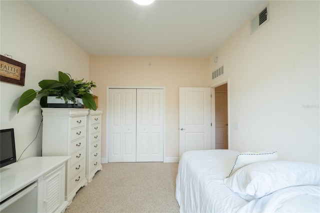 bedroom featuring a closet and light carpet