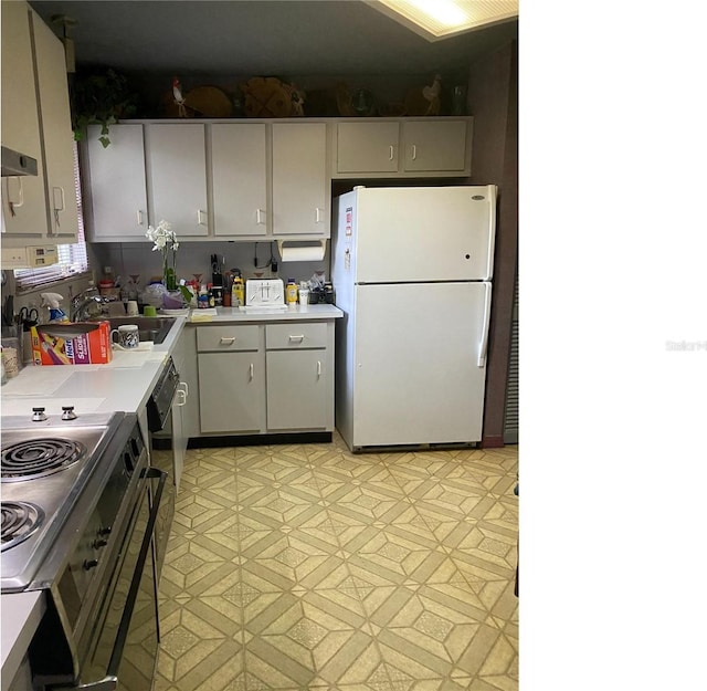 kitchen featuring light tile patterned flooring, sink, white fridge, and wall chimney exhaust hood