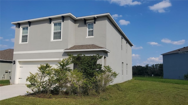 exterior space featuring a garage and a yard