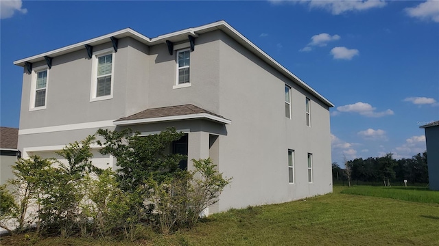 view of property exterior with a yard