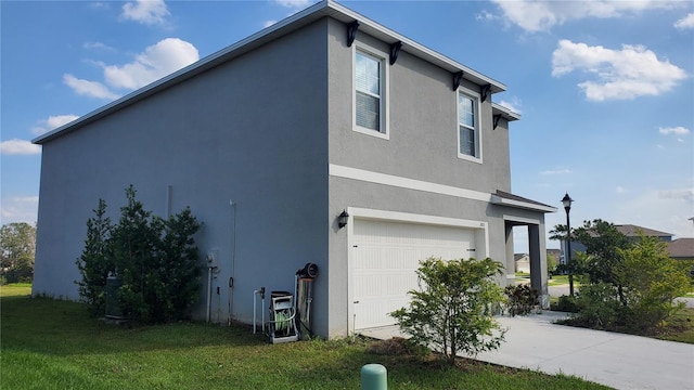 view of side of home featuring a garage and a yard