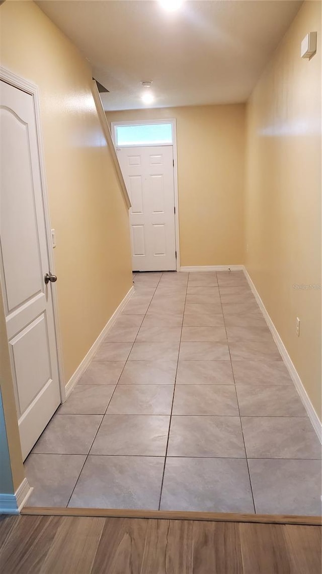 hall featuring light tile patterned floors