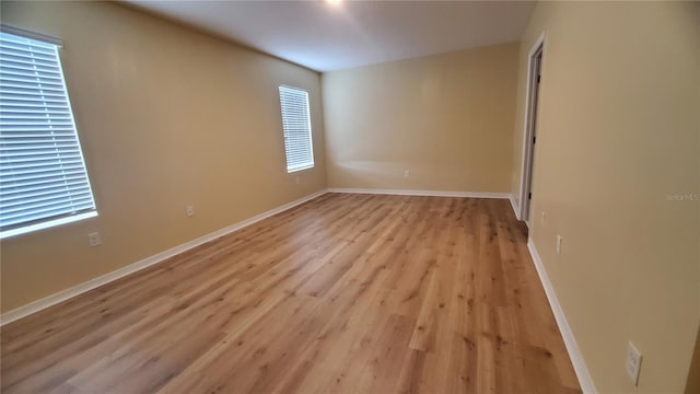 spare room with light hardwood / wood-style flooring