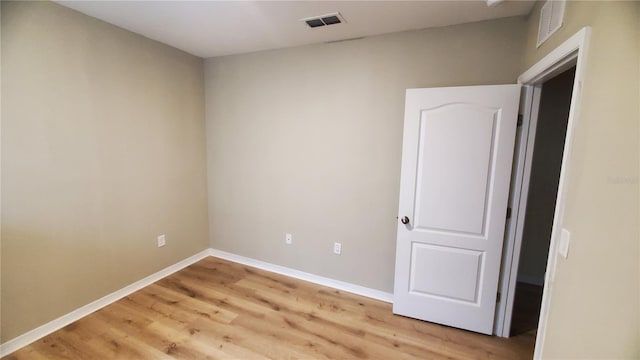 spare room with light wood-type flooring