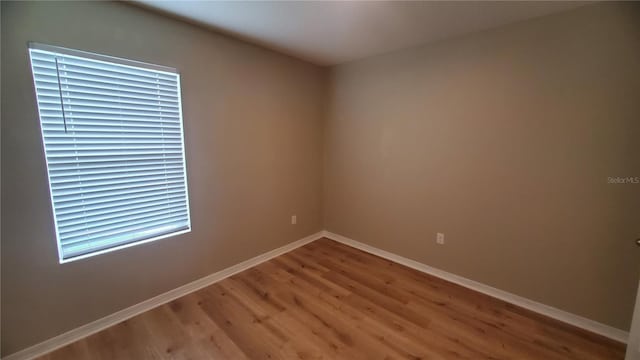 unfurnished room with hardwood / wood-style floors