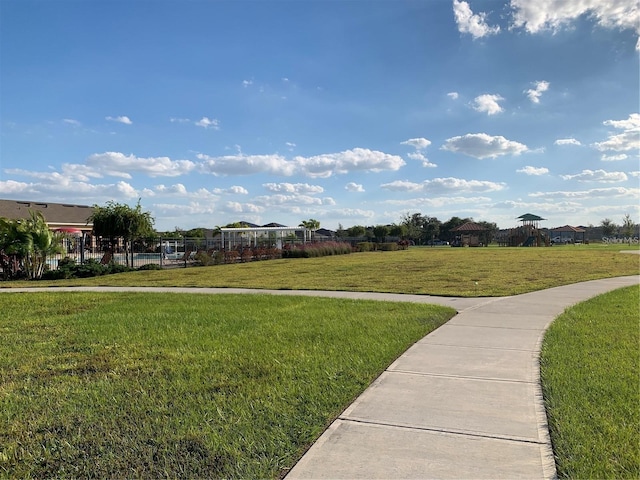 view of property's community with a yard