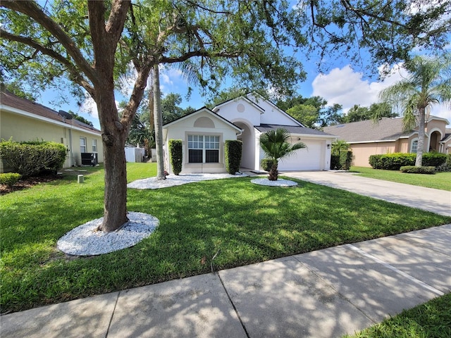 ranch-style house with a garage, central AC, and a front yard