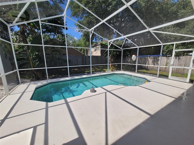 view of swimming pool with a patio area and glass enclosure