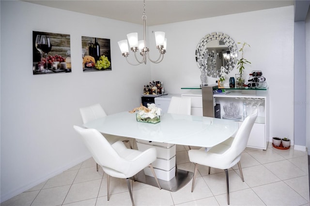 tiled dining space featuring a notable chandelier