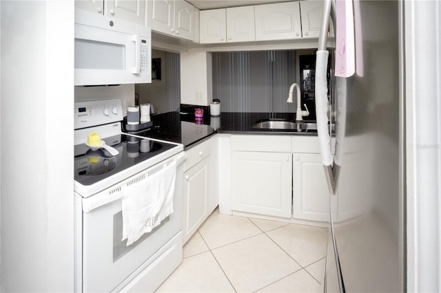 kitchen with white cabinetry, sink, white appliances, and light tile patterned floors