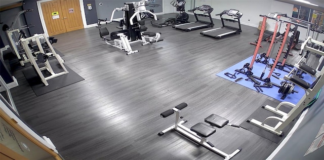 workout area with dark hardwood / wood-style floors