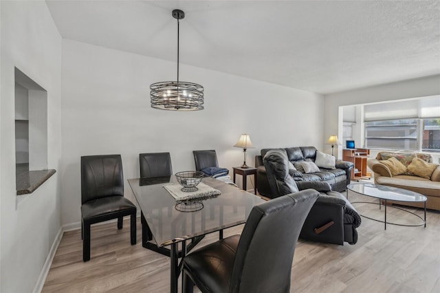 dining room featuring light hardwood / wood-style flooring and a chandelier