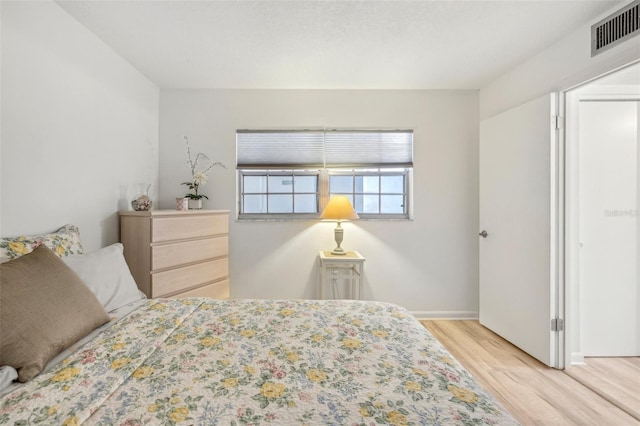 bedroom with light wood-type flooring