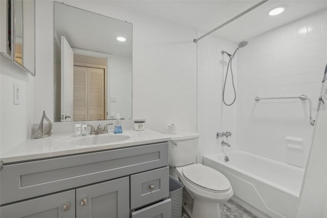 full bathroom featuring toilet, vanity, and tiled shower / bath