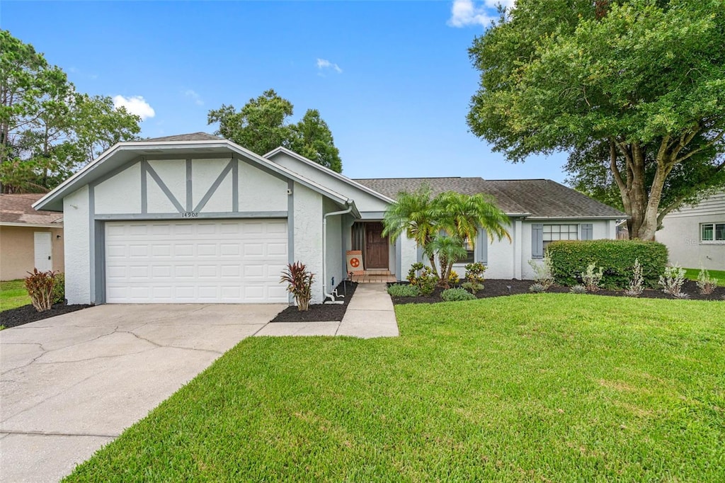 view of front of home featuring a front yard and a garage