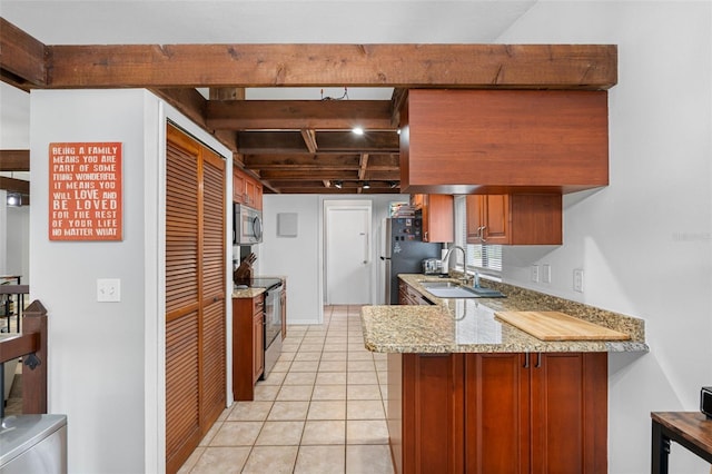 kitchen with kitchen peninsula, stainless steel appliances, light tile patterned flooring, light stone counters, and sink