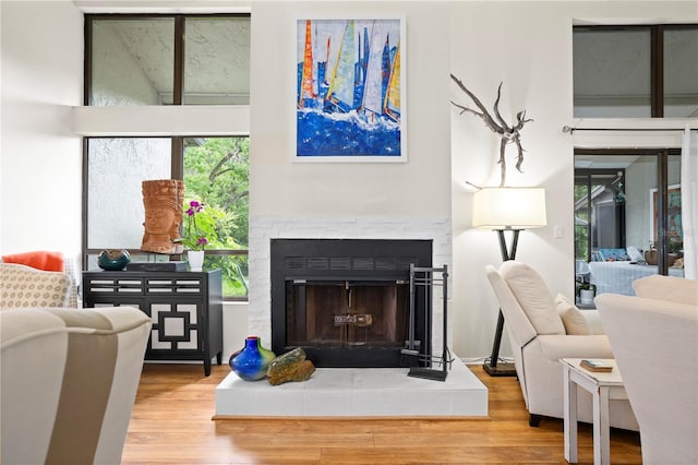 sitting room featuring a fireplace and hardwood / wood-style flooring