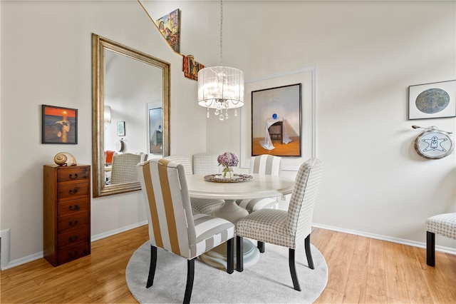 dining room featuring light hardwood / wood-style floors and a notable chandelier