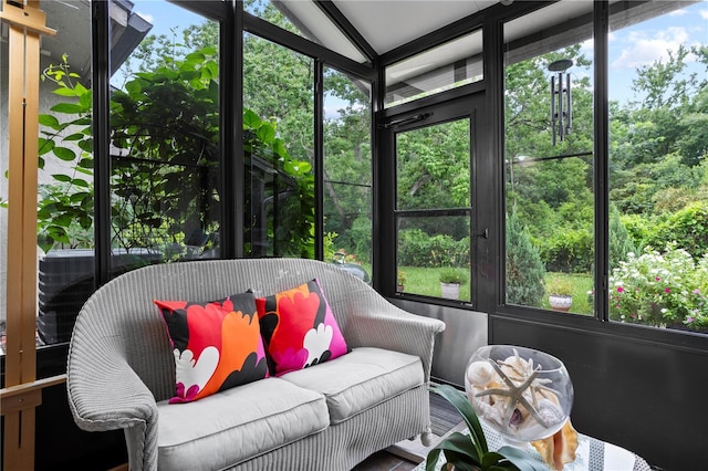 sunroom featuring vaulted ceiling