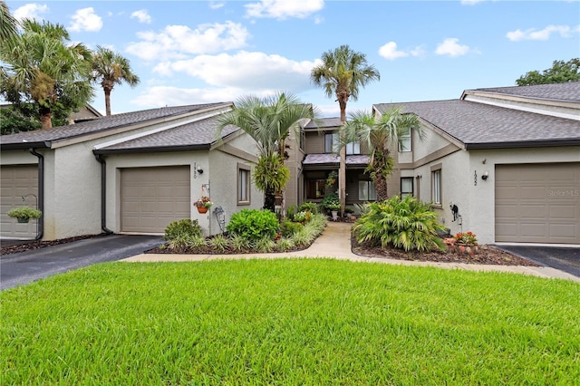 view of front of property with a front lawn and a garage