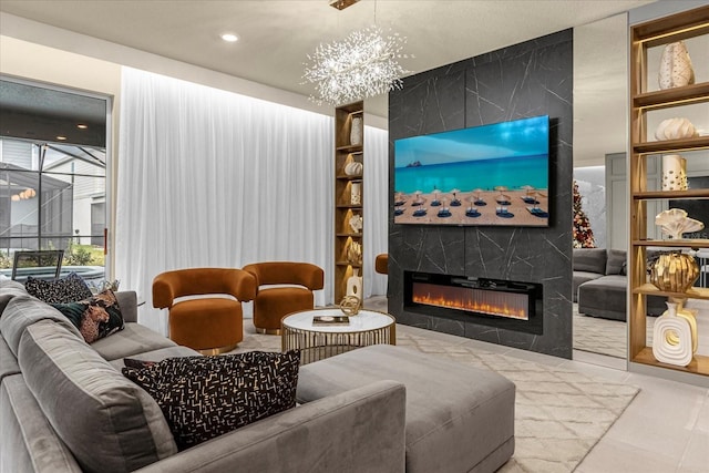 living room featuring a large fireplace, tile patterned floors, and a chandelier