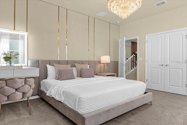 bedroom featuring an inviting chandelier and carpet