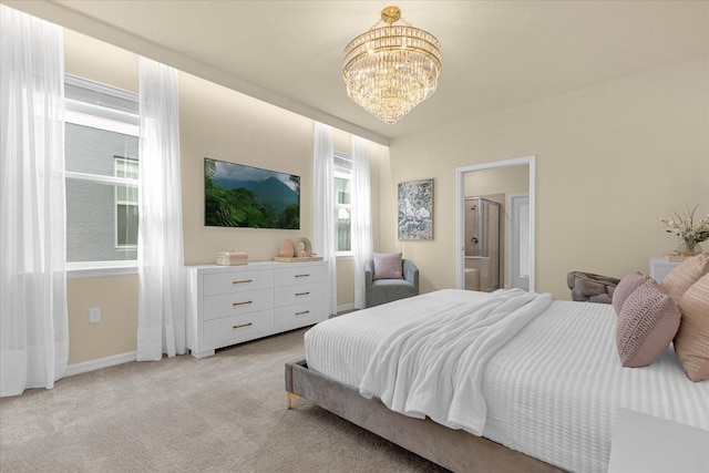 bedroom with a notable chandelier and light colored carpet