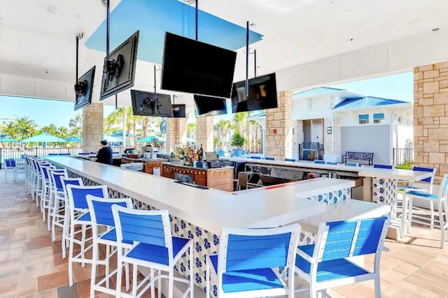 kitchen featuring hanging light fixtures, light tile patterned flooring, a center island, and a wealth of natural light