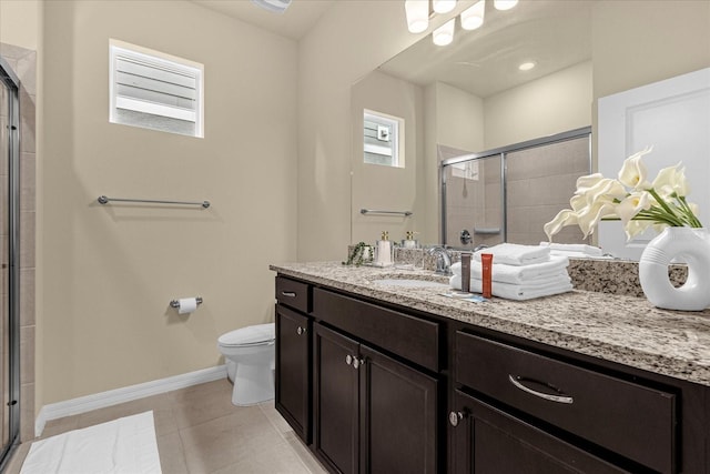 bathroom with vanity, walk in shower, tile patterned flooring, and toilet