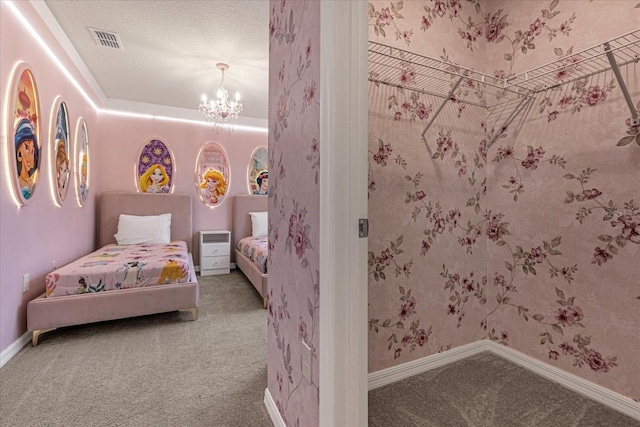 bedroom featuring carpet floors, a textured ceiling, and a notable chandelier