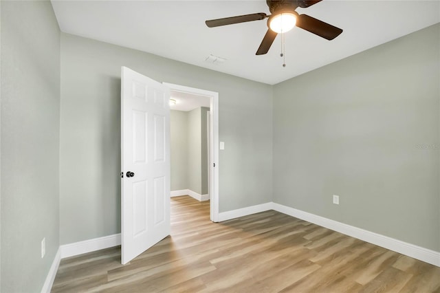 spare room featuring ceiling fan and light hardwood / wood-style flooring