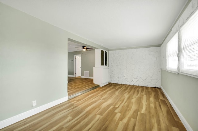 unfurnished room featuring ceiling fan and light hardwood / wood-style floors