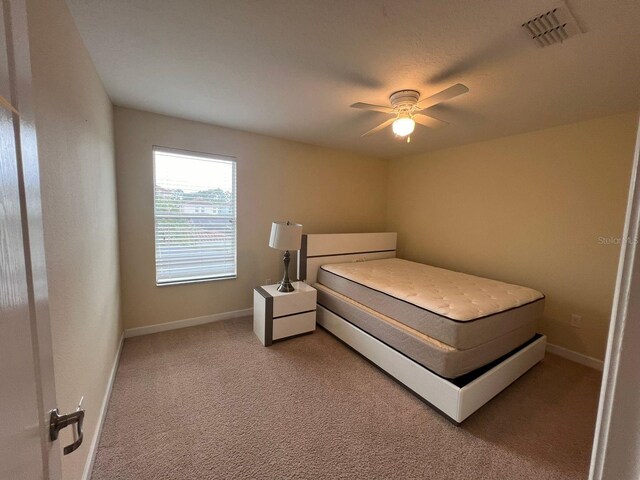 bedroom with ceiling fan and carpet floors