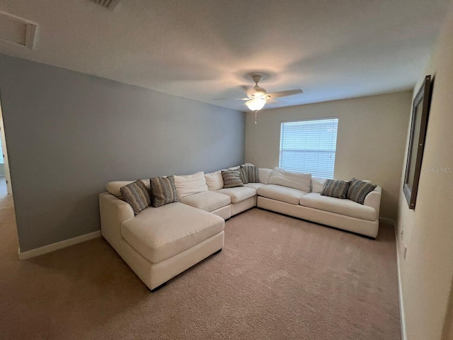 living room with ceiling fan and carpet