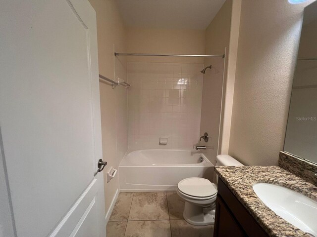 full bathroom with tile patterned floors, toilet, vanity, and tiled shower / bath