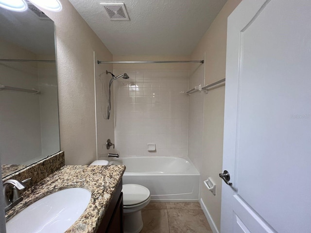 full bathroom featuring toilet, vanity, tile patterned flooring, tiled shower / bath combo, and a textured ceiling